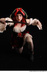 DARINA KNEELING POSES WITH DAGGER 